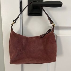Dark mauve coach suede bag with gold accents